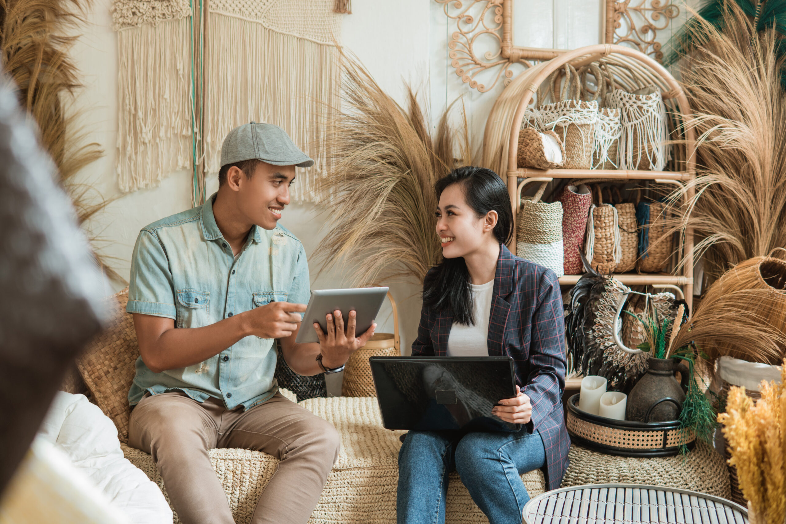 retailers looking at POS reports on tablet and laptop
