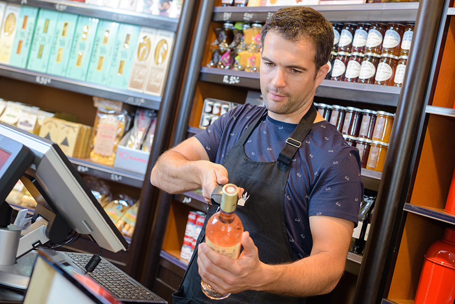 Liquor Store Cashier W/ bottle of wine