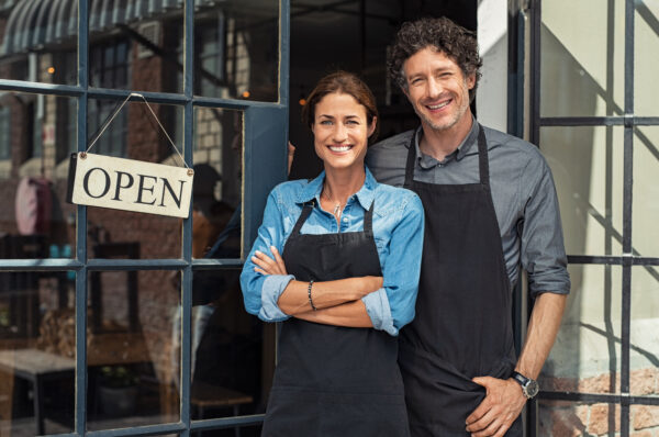 Small business owners couple Mom and Pop shop with woman and man next to door