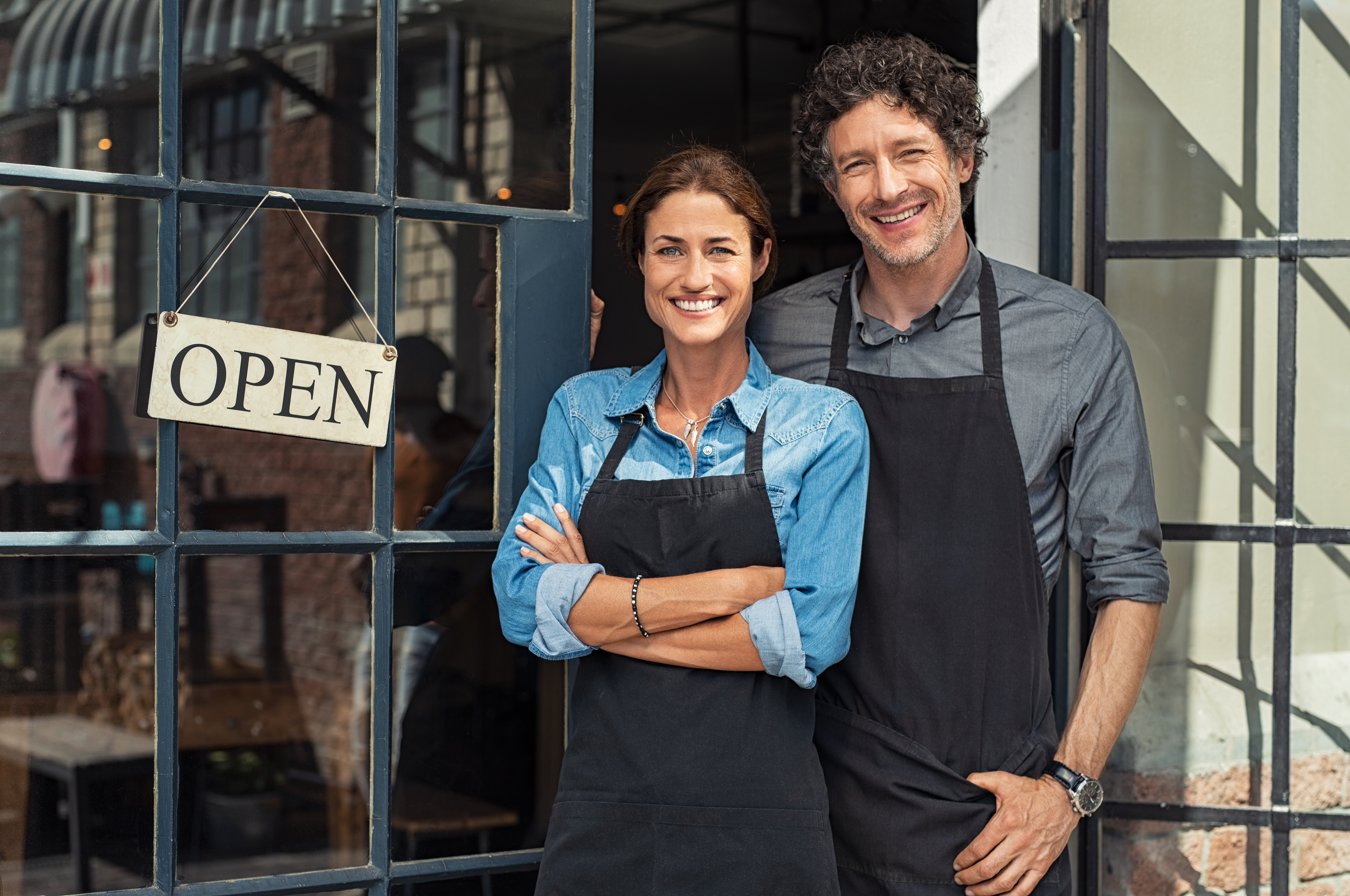 Mom and Pop shop with woman and man next to door