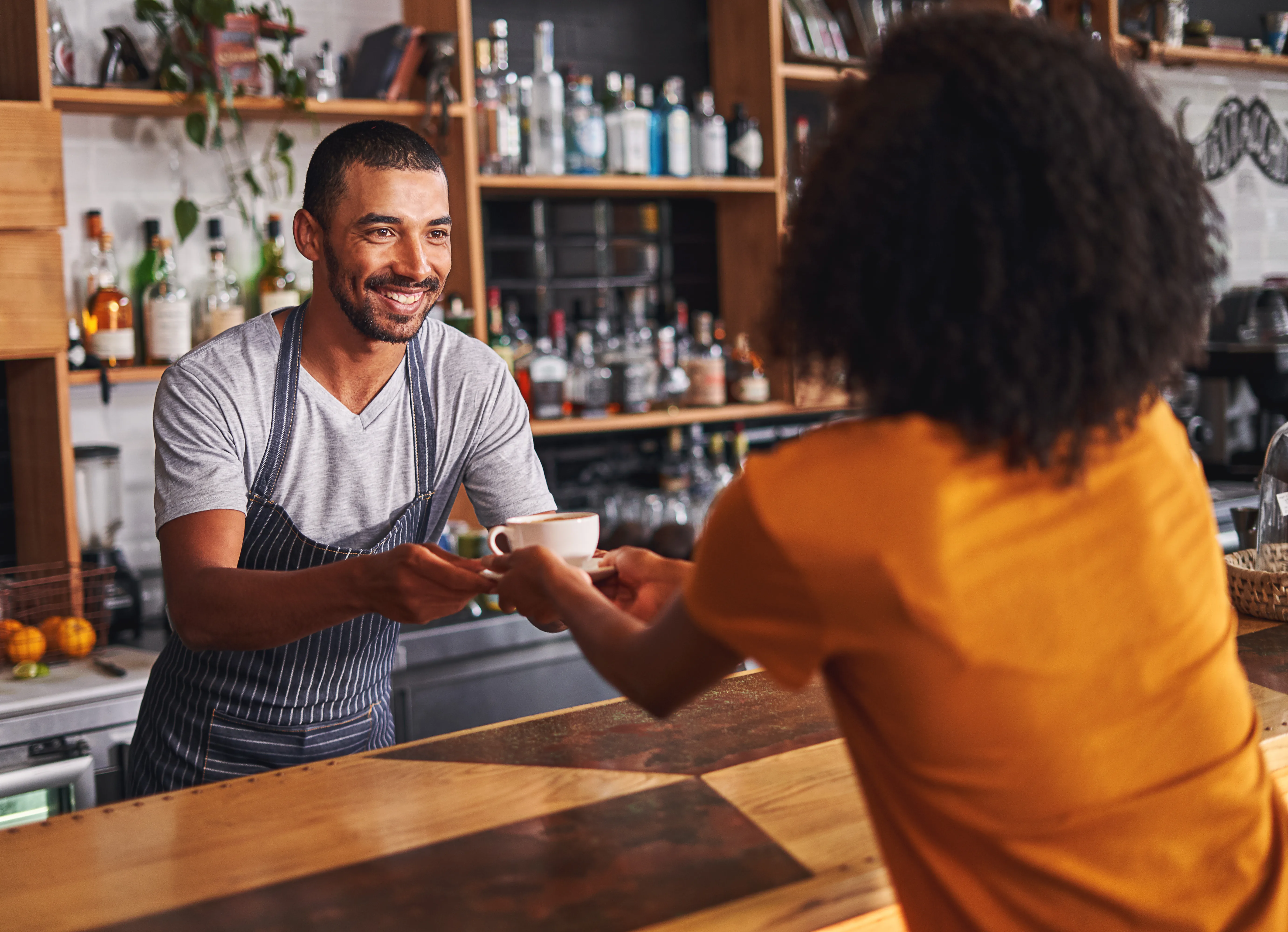 Barista handing over coffee in cafe