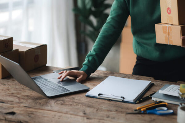 A person is using a laptop. Business owner opens an online store