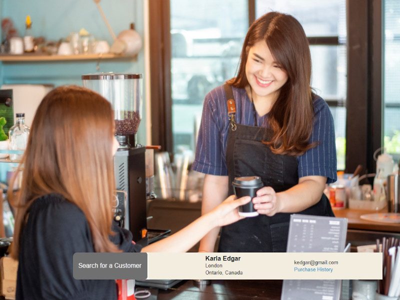 woman handing customer coffee with customer marketing POS window